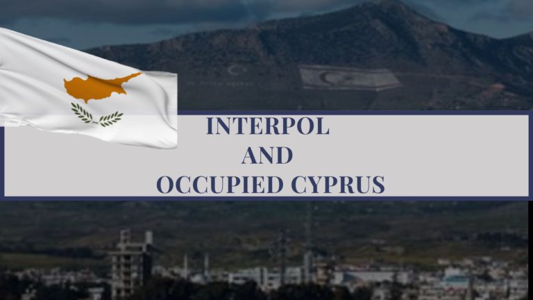 A landscape view of Cyprus with coastal mountains, used to illustrate INTERPOL, extradition issues, and the occupied area of Northern Cyprus.